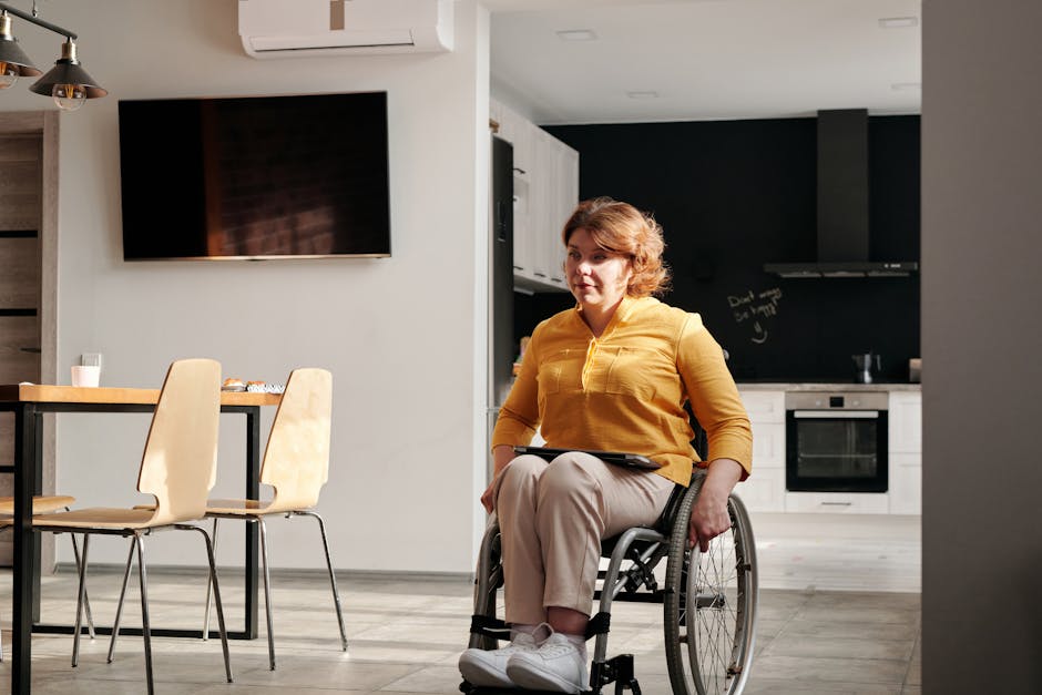 A woman in a wheelchair enjoys her accessible kitchen space, highlighting inclusive home design.